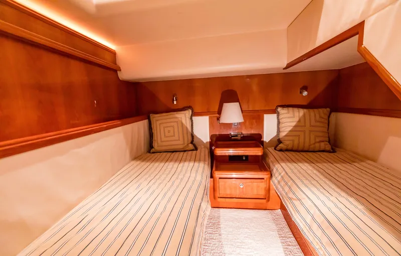  Yacht Photos Pics Luxurious twin cabin interior of 2007 Bertram 570 yacht with elegant wood finish.