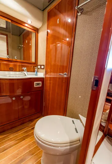  Yacht Photos Pics Luxurious bathroom in a 2007 Bertram 570 yacht with wooden finishes and modern fixtures.