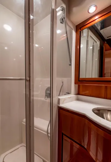  Yacht Photos Pics Luxurious bathroom in 2007 Bertram 570 yacht with shower and wooden cabinetry.
