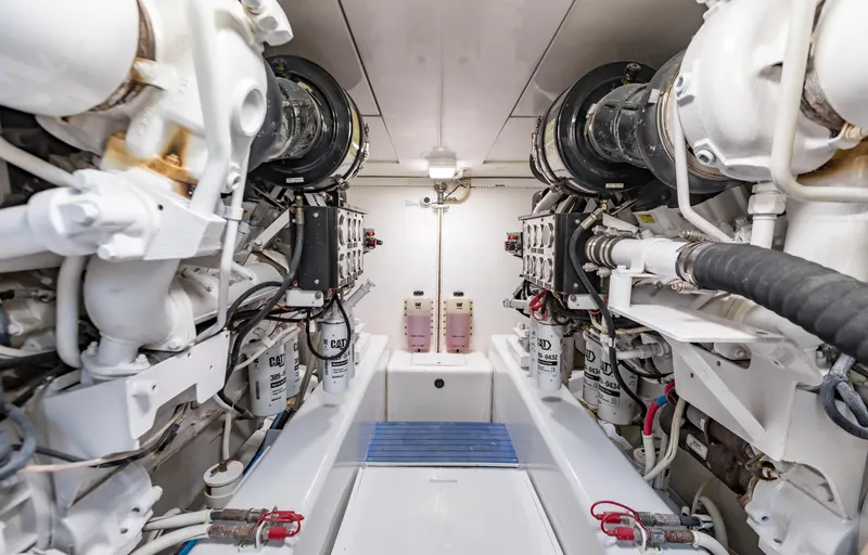  Yacht Photos Pics Engine room of a 2007 Bertram 570 yacht, showcasing dual engines and mechanical components.