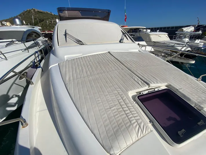  Yacht Photos Pics 2012 Ferretti Yachts 500 with sunbathing area, docked in a marina under clear skies.
