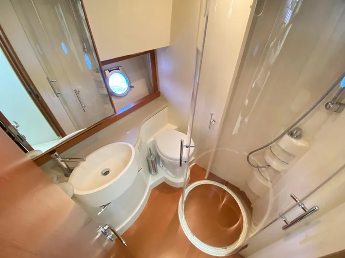  Yacht Photos Pics Luxurious bathroom in 2012 Ferretti Yachts 500, featuring modern fixtures and porthole window.