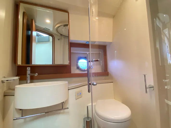  Yacht Photos Pics Luxurious bathroom in 2012 Ferretti Yachts 500, featuring modern fixtures and porthole window.