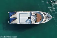 Aerial view of 2024 Custom 29m Charter MY yacht on turquoise water.