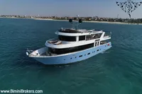 Luxurious 2024 Custom 29m Charter MY yacht cruising near a scenic coastline.