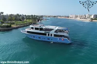 Luxury 2024 Custom 29m Charter MY yacht cruising near a scenic coastline.