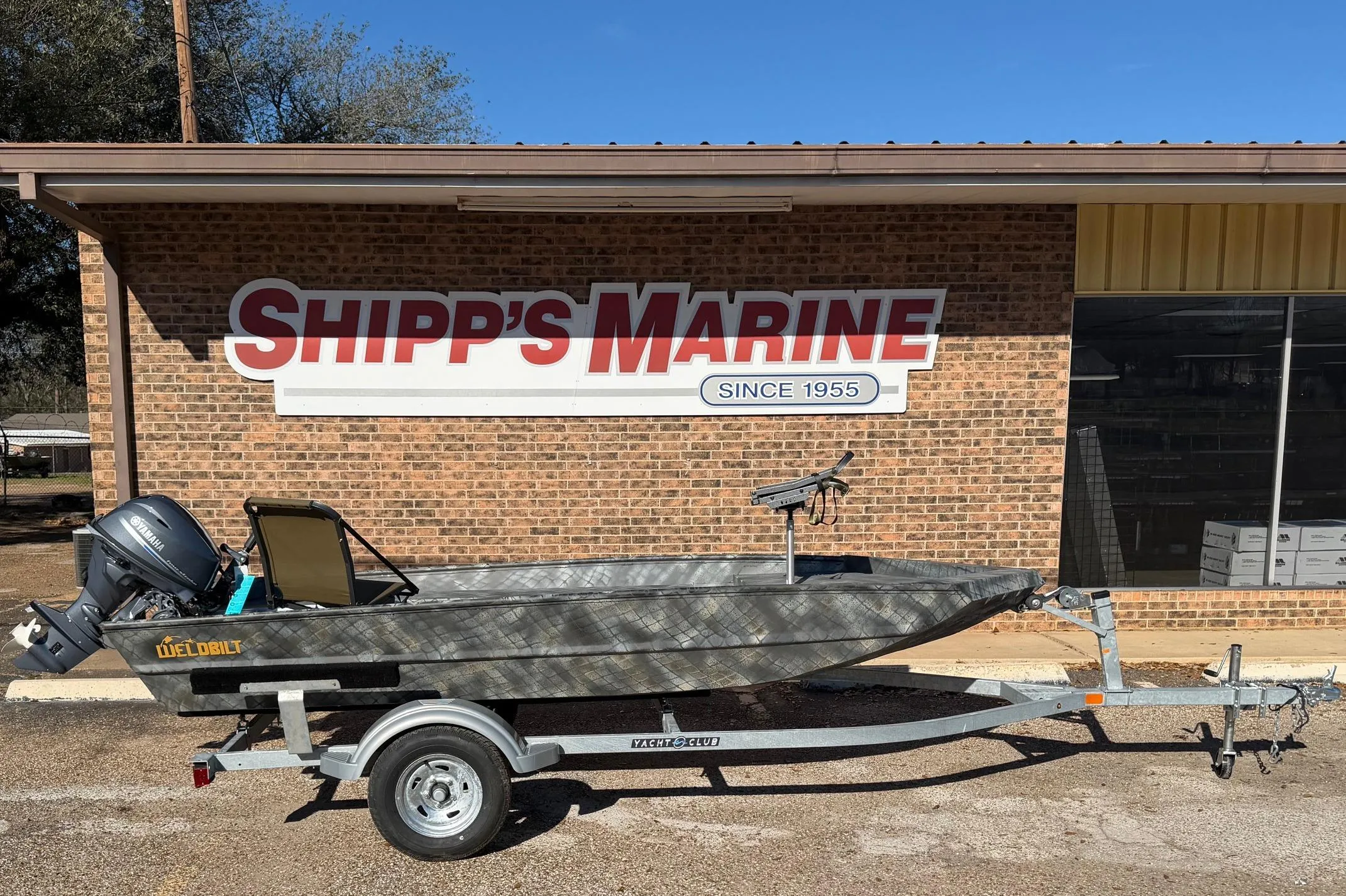 2025 WeldBilt 1448 boat on trailer outside Shipp's Marine store.