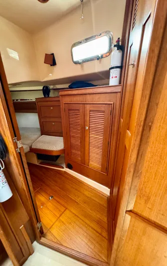 TinteÁn Yacht Photos Pics Interior cabin of 2000 Island Packet 40 sailboat with wooden furnishings and storage.