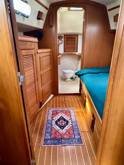 TinteÁn Yacht Photos Pics Interior of 2000 Island Packet 40 sailboat with wooden cabinetry and cozy sleeping area.