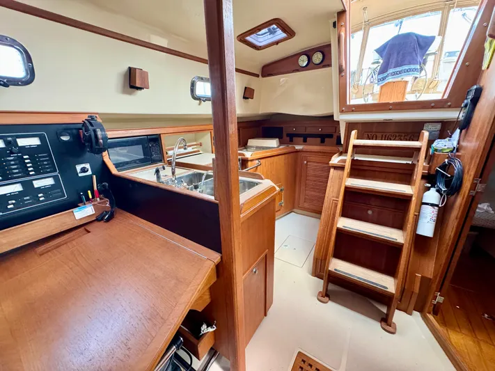 TinteÁn Yacht Photos Pics Interior of 2000 Island Packet 40 sailboat with wooden cabinetry and stairs.