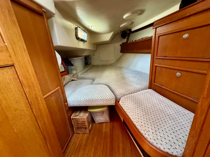 TinteÁn Yacht Photos Pics Cozy cabin interior of 2000 Island Packet 40 sailboat with wooden furnishings.