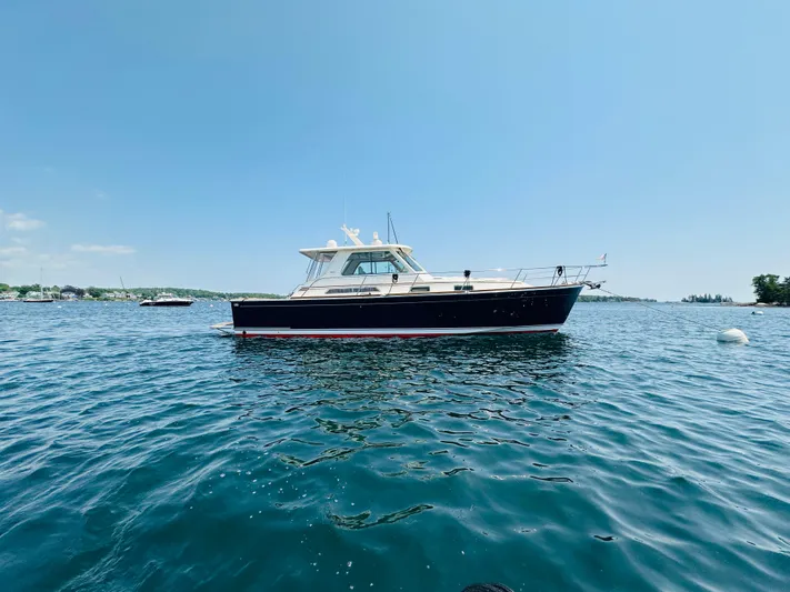 Slipped Away Yacht Photos Pics 2008 Sabre 42 Hardtop Express yacht on calm blue water under clear sky.
