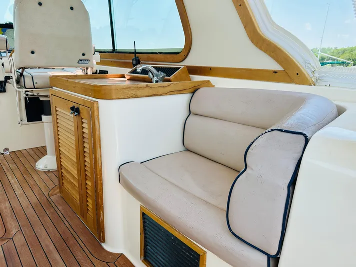 Slipped Away Yacht Photos Pics 2008 Sabre 42 Hardtop Express interior with beige seating and wooden accents.