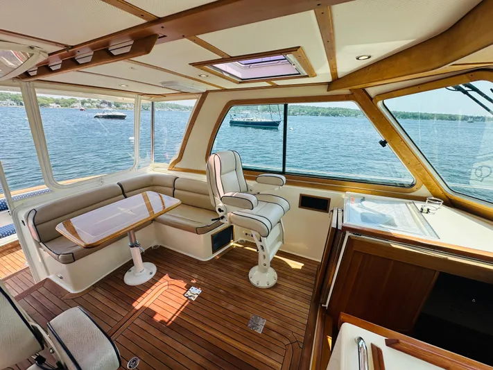 Slipped Away Yacht Photos Pics Interior of 2008 Sabre 42 Hardtop Express yacht with wood finish and scenic water view.