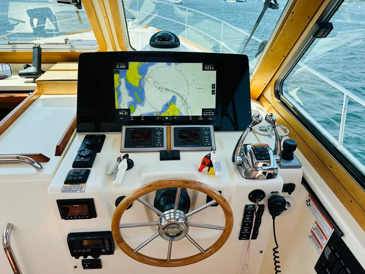 Slipped Away Yacht Photos Pics Helm of 2008 Sabre 42 Hardtop Express with navigation display and controls.