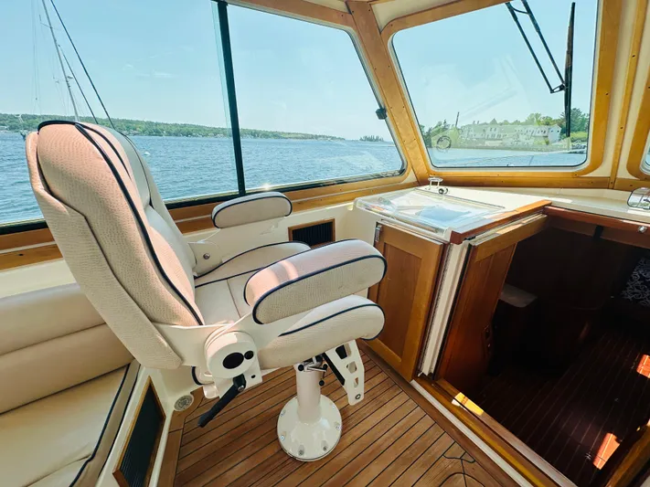 Slipped Away Yacht Photos Pics 2008 Sabre 42 Hardtop Express interior with captain's chair and scenic water view.