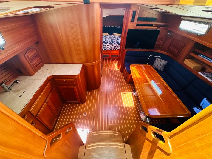Slipped Away Yacht Photos Pics Interior of 2008 Sabre 42 Hardtop Express yacht with wood finish and seating area.