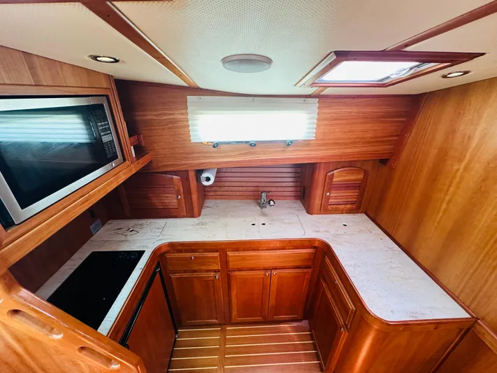 Slipped Away Yacht Photos Pics 2008 Sabre 42 Hardtop Express galley with wood cabinetry, countertop, and built-in microwave.