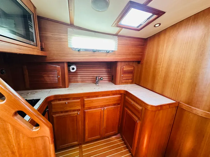 Slipped Away Yacht Photos Pics 2008 Sabre 42 Hardtop Express yacht interior with wooden cabinetry and countertop.
