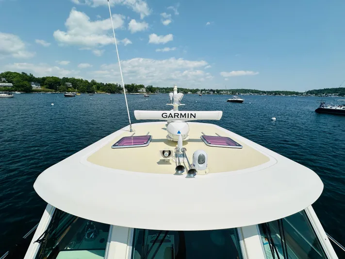 Slipped Away Yacht Photos Pics 2008 Sabre 42 Hardtop Express yacht on water, featuring Garmin equipment, under clear sky.