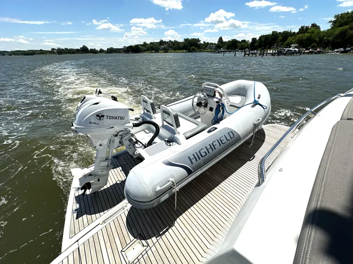  Yacht Photos Pics Inflatable boat with Tohatsu motor on Prestige 500 yacht, 2017 model, cruising on a sunny lake.