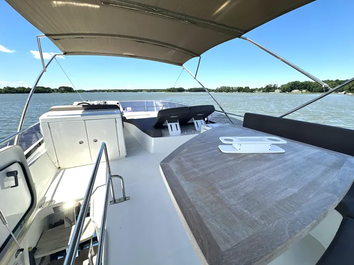  Yacht Photos Pics Flybridge of 2017 Prestige 500 yacht with seating and canopy on a sunny day.