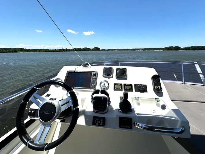  Yacht Photos Pics Helm of 2017 Prestige 500 yacht with navigational controls on a sunny day.