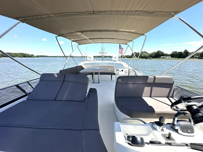  Yacht Photos Pics Luxurious 2017 Prestige 500 yacht with spacious deck and seating, cruising on a serene lake.