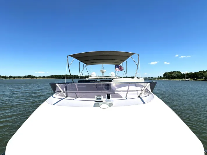  Yacht Photos Pics Front view of a 2017 Prestige 500 yacht on a sunny day, with clear blue skies.