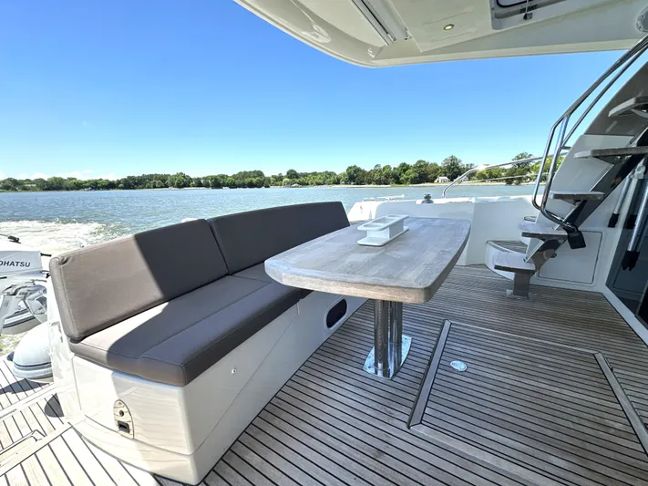  Yacht Photos Pics Prestige 500 yacht deck with seating, table, and scenic water view, 2017 model.