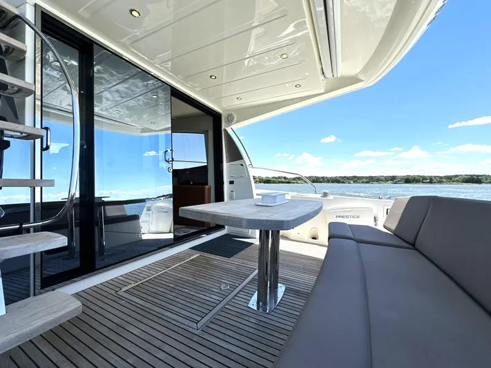  Yacht Photos Pics Luxurious 2017 Prestige 500 yacht deck with seating, table, and ocean view.