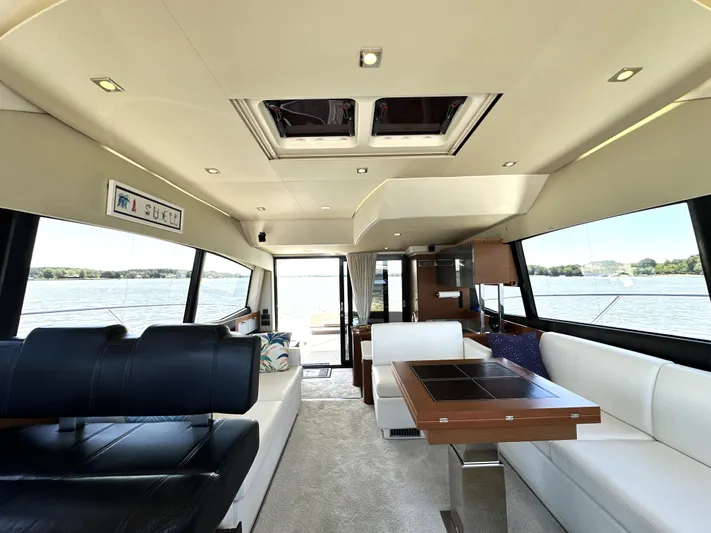  Yacht Photos Pics Luxurious interior of a 2017 Prestige 500 yacht with elegant seating and panoramic windows.