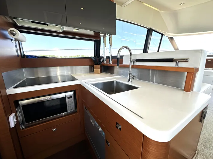  Yacht Photos Pics Modern kitchen interior on a 2017 Prestige 500 yacht, featuring sleek countertops and appliances.