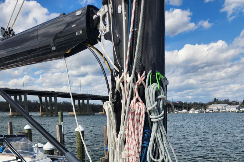 Pinnacle Yacht Photos Pics 2023 Hallberg-Rassy 57 sailboat mast and rigging by a waterfront marina.