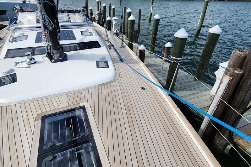 Pinnacle Yacht Photos Pics 2023 Hallberg-Rassy 57 yacht docked, showcasing sleek deck design and modern features.