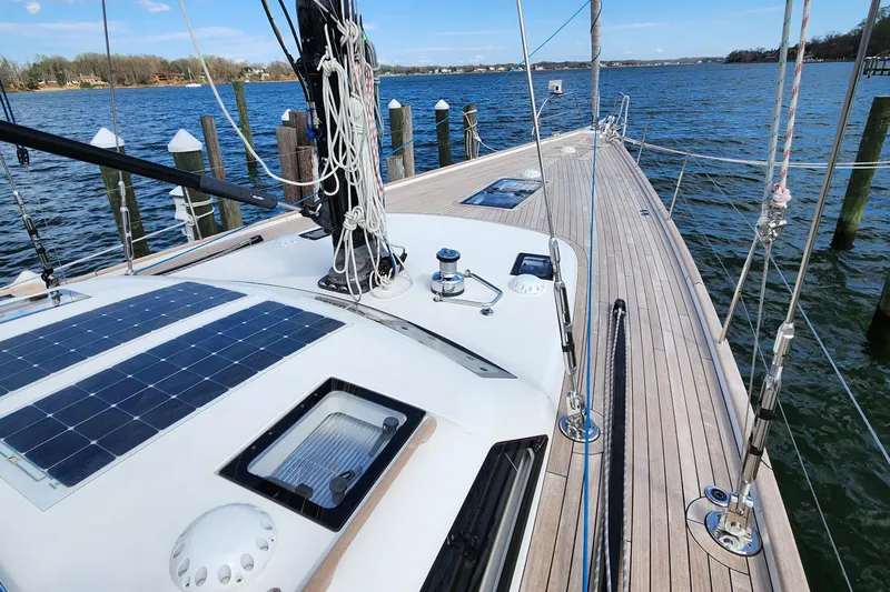 Pinnacle Yacht Photos Pics 2023 Hallberg-Rassy 57 yacht deck with solar panels, docked by the water.