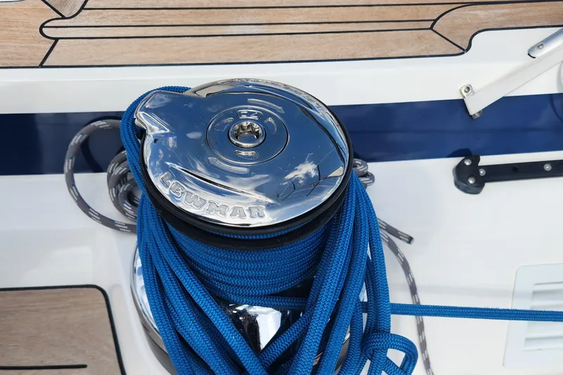 Pinnacle Yacht Photos Pics Winch with blue rope on 2023 Hallberg-Rassy 57 yacht deck.