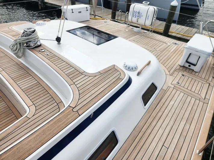 Pinnacle Yacht Photos Pics 2023 Hallberg-Rassy 57 yacht deck with teak wood finish and sleek design.