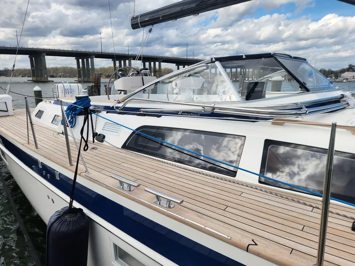 Pinnacle Yacht Photos Pics 2023 Hallberg-Rassy 57 yacht docked, showcasing sleek design and spacious deck.