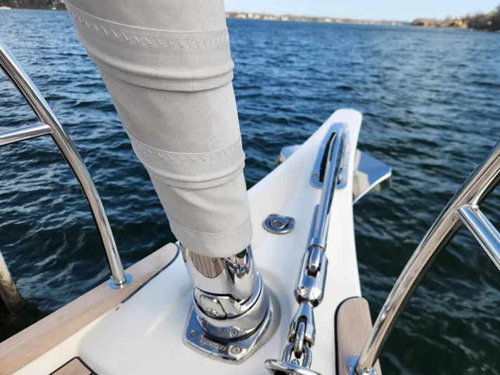 Pinnacle Yacht Photos Pics Bow of 2023 Hallberg-Rassy 57 yacht with stainless steel fittings and ocean view.