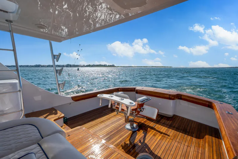 Let's Ride Yacht Photos Pics Luxurious 2004 Sculley Custom Carolina 58' Sportfish yacht on open water, sunny day.