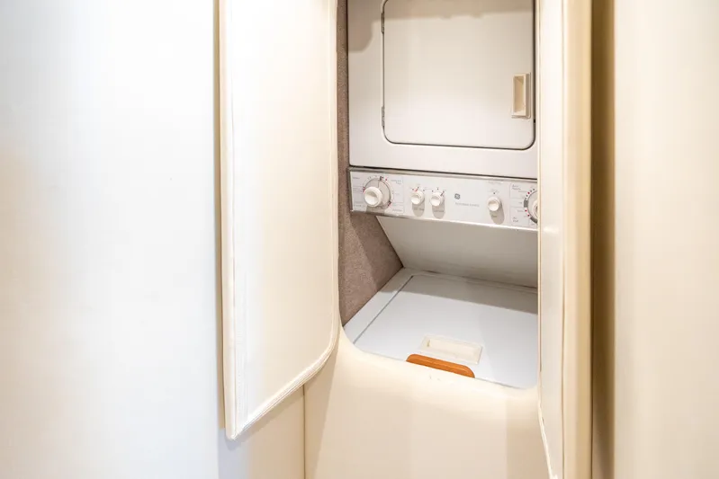 Let's Ride Yacht Photos Pics Laundry area inside 2004 Sculley Custom Carolina 58' Sportfish yacht, featuring a compact washer-dryer.