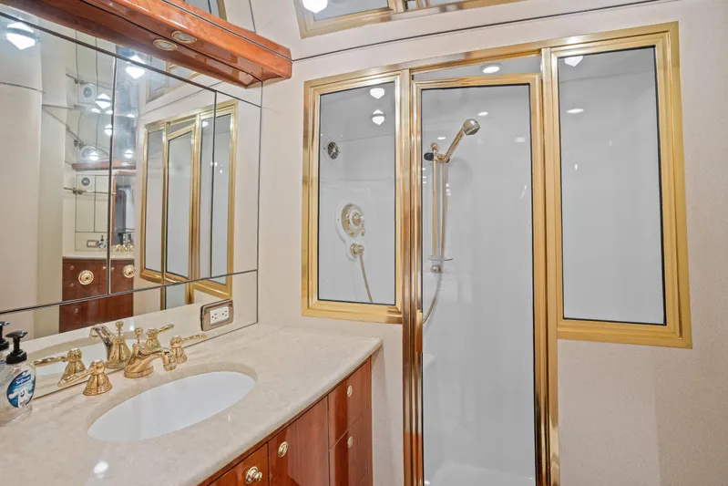 Let's Ride Yacht Photos Pics Luxurious bathroom on 2004 Sculley Custom Carolina 58' Sportfish yacht with gold accents.