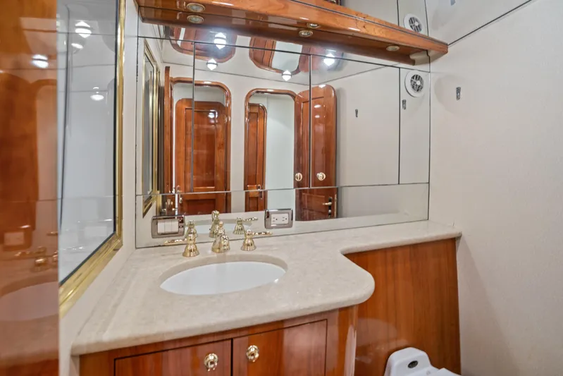 Let's Ride Yacht Photos Pics Luxurious bathroom in 2004 Sculley Custom Carolina 58' Sportfish yacht with elegant wood finishes.
