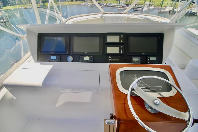 Let's Ride Yacht Photos Pics Helm of 2004 Sculley Custom Carolina 58' Sportfish with navigation screens and steering wheel.