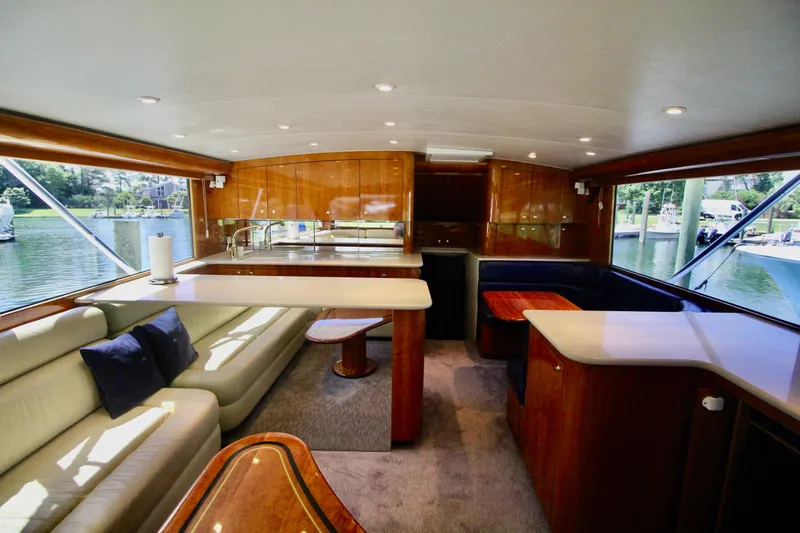 Let's Ride Yacht Photos Pics Luxurious interior of a 2004 Sculley Custom Carolina 58' Sportfish yacht with elegant wood finishes.