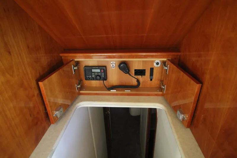 Let's Ride Yacht Photos Pics 2004 Sculley Custom Carolina 58' Sportfish interior with wooden cabinetry and communication equipment.