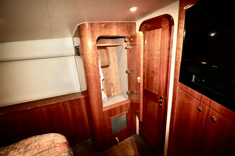 Let's Ride Yacht Photos Pics Luxurious interior of 2004 Sculley Custom Carolina 58' Sportfish with wood finishes and modern amenities.