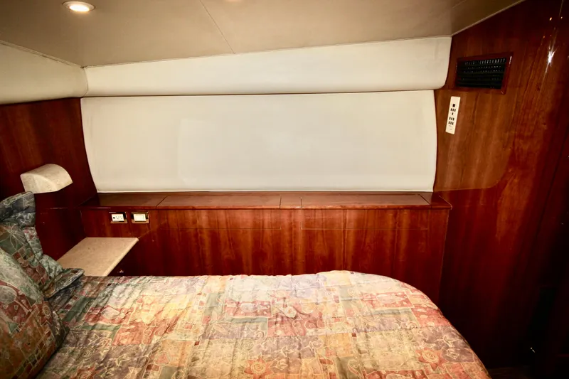 Let's Ride Yacht Photos Pics Luxurious cabin interior of 2004 Sculley Custom Carolina 58' Sportfish with wood paneling.