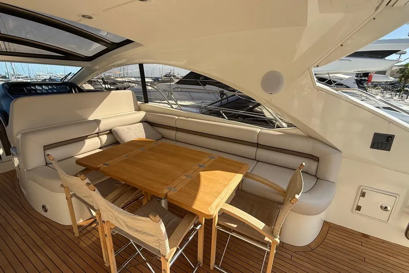 Helios Yacht Photos Pics Luxurious Sunseeker Predator 60 yacht interior with elegant seating and wooden table, 2010 model.